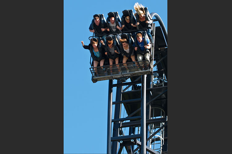 Photo of people riding a rollercoaster