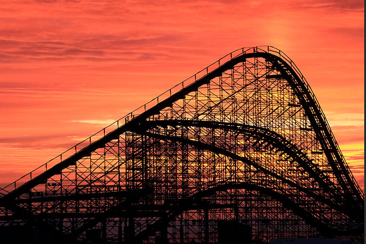 Photo of a tall rollercoaster at sunset