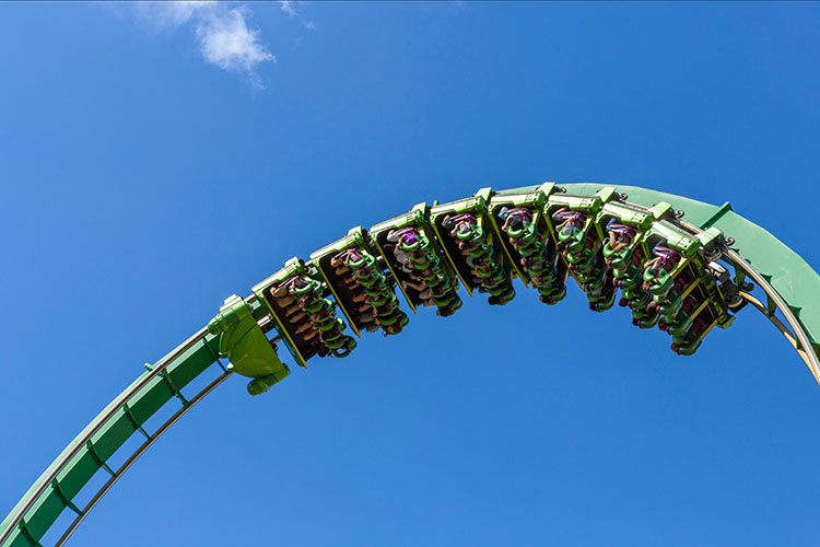 Photo of people riding an upside-down rollercoaster