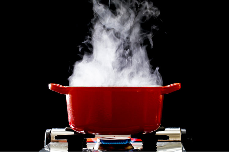 Image of a pan on the stove with steam rising